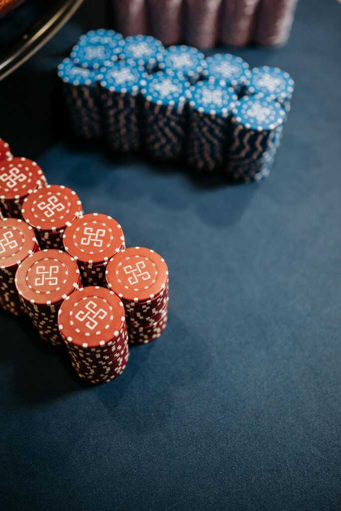 Close-up view of colorful poker chips neatly stacked on a casino table.